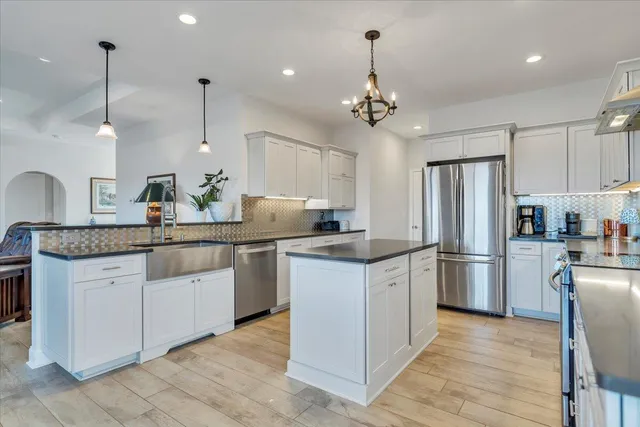 a bedroom with bed and a chandelier