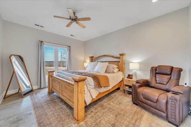 a bedroom with a bed desk and a window