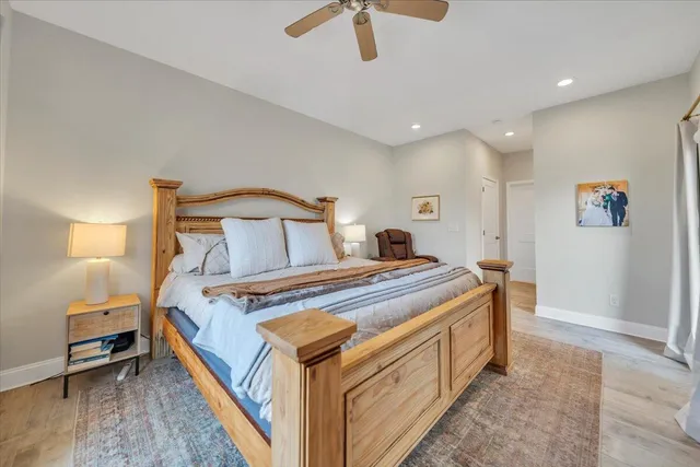 a view of a livingroom with furniture hardwood floor and a ceiling fan
