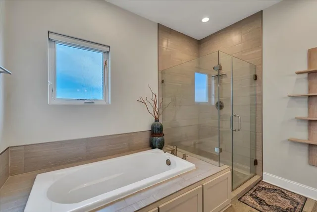 a dining room with furniture and a chandelier fan