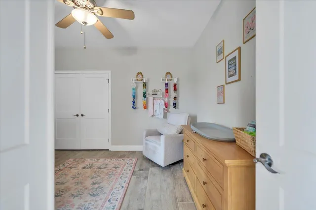 a living room with furniture a rug and white walls
