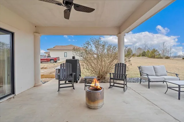a view of a white house with a big yard and large trees