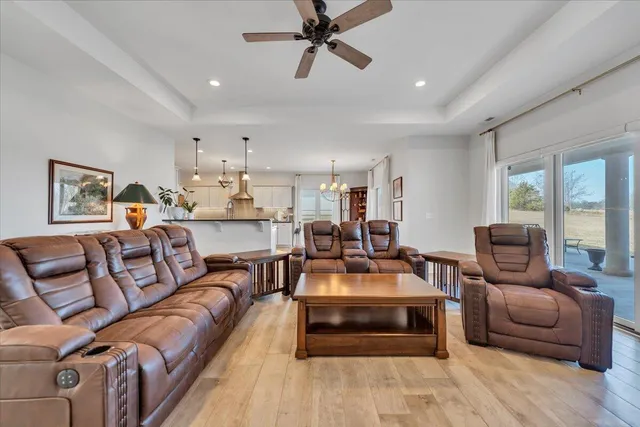 a living room with furniture a ceiling fan and a rug