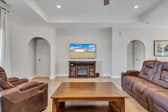 a kitchen with stainless steel appliances granite countertop a dining table chairs refrigerator and cabinets