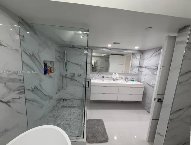 a kitchen with stainless steel appliances granite countertop a sink a stove and a refrigerator