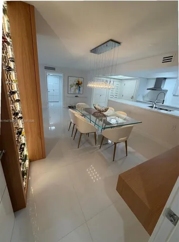 a view of a dining room with furniture and a chandelier