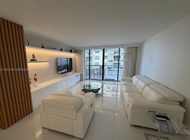 a living room with furniture and a mirror