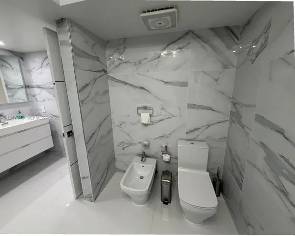 a living room with furniture and a painting on the wall