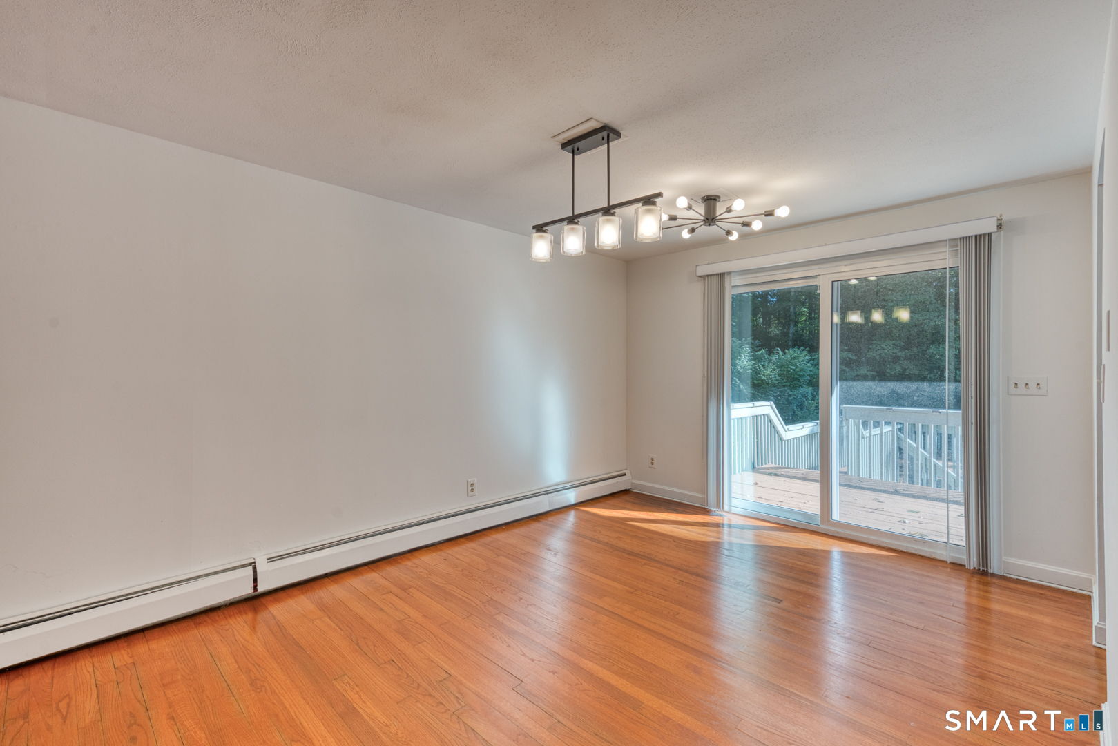 16 Westgate Lane Mansfield, CT 06268 - Photo 15 of 40 a view of a livingroom with wooden floor and a large window