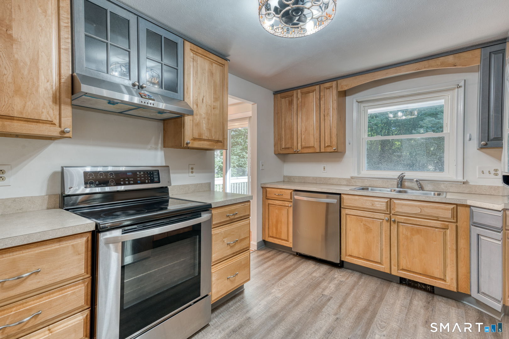 16 Westgate Lane Mansfield, CT 06268 - Photo 18 of 40 a kitchen with cabinets wooden floor and stainless steel appliances