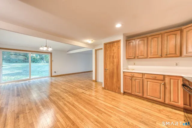a view of a kitchen with wooden floor and cabinet