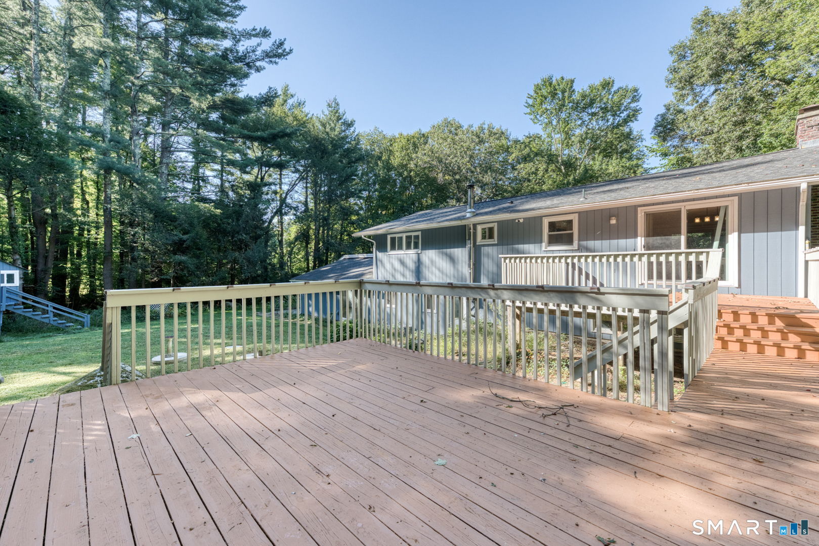 16 Westgate Lane Mansfield, CT 06268 - Photo 8 of 40 a view of a deck with wooden floor and fence with a large garden