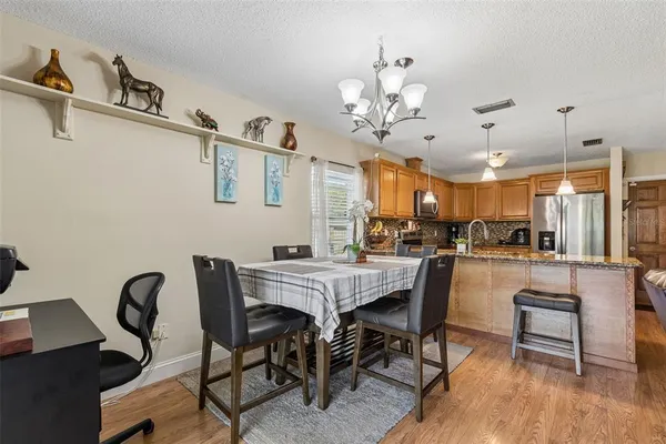 a view of a dining room with furniture and wooden floor