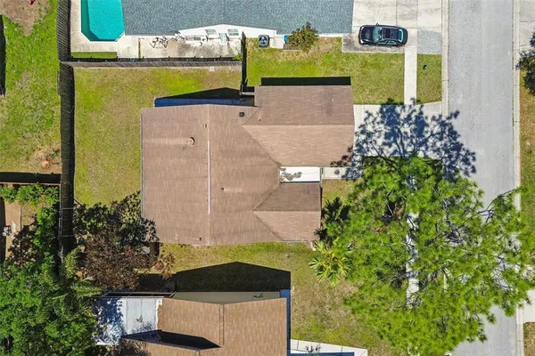 an aerial view of a house with a swimming pool