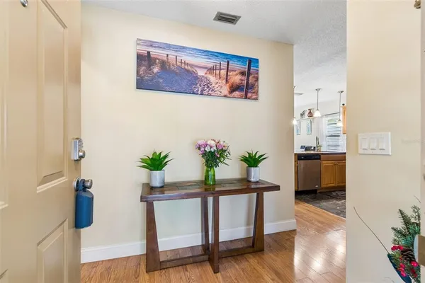 a dining room with furniture and wooden floor