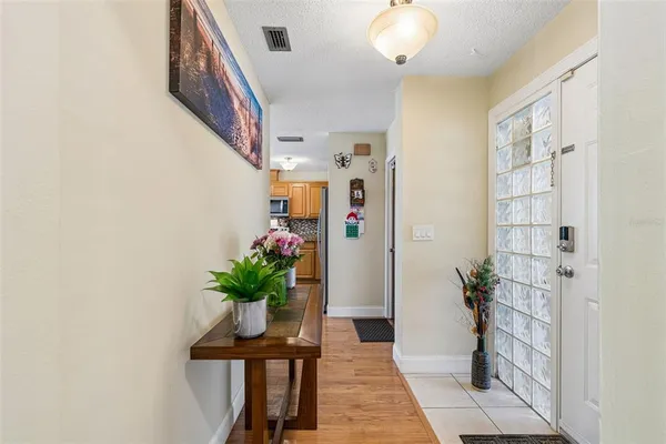 a view of a hallway with furniture and a potted plant