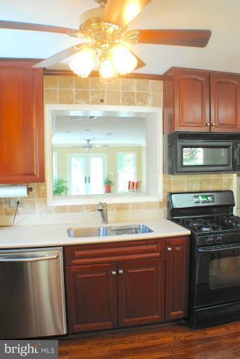 7926 Bainbridge Road Alexandria, VA 22308 - Photo 1 of 20 Cherry Cabinets and Corian Countertops