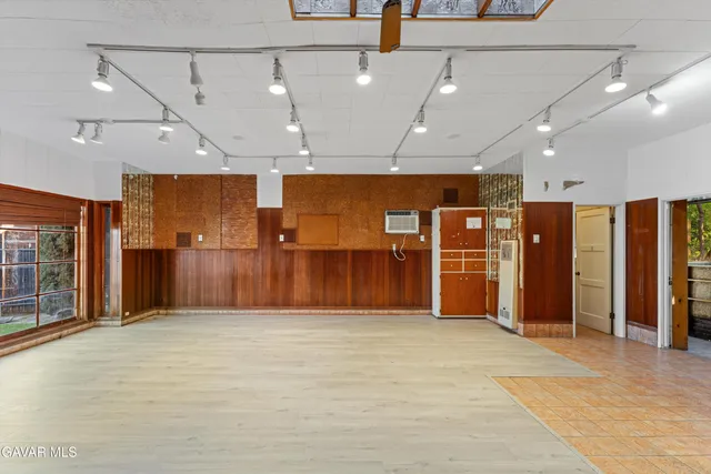 a view of a hall with wooden floor