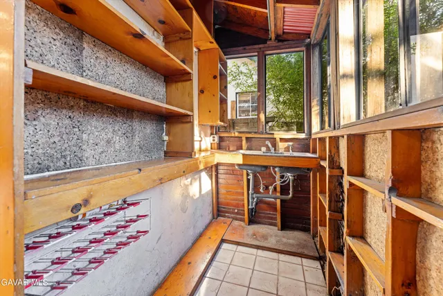 a view of a porch with wooden floor and iron stairs