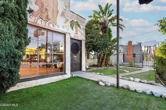 a view of a house with a yard and plants