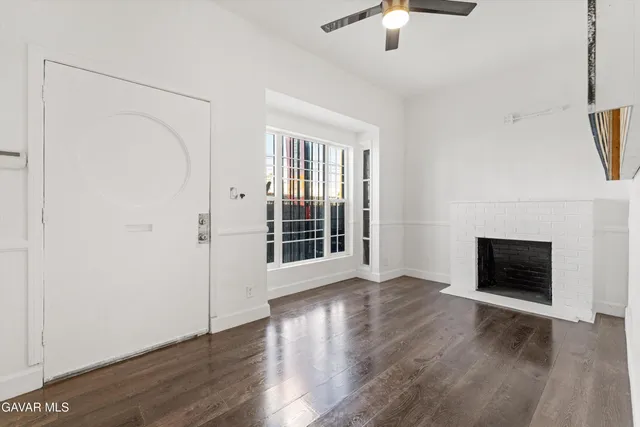 a bedroom with two beds and a chair