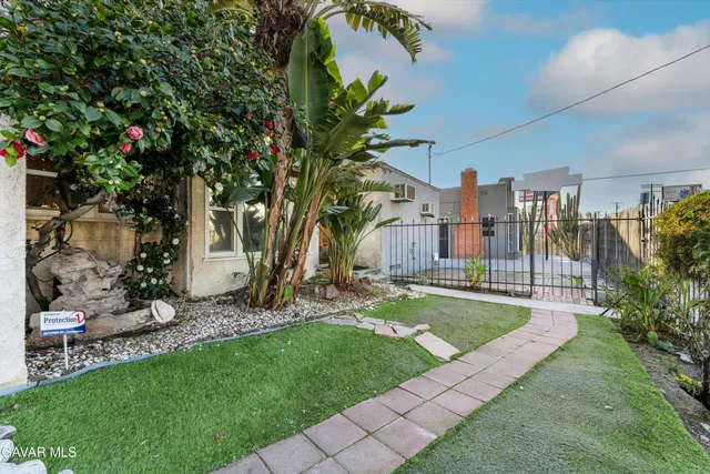a front view of a house with garden
