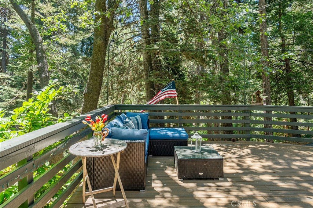 816 Fern Road Lake Arrowhead, CA 92385 - Photo 12 of 35 a patio with table and chairs and potted plants