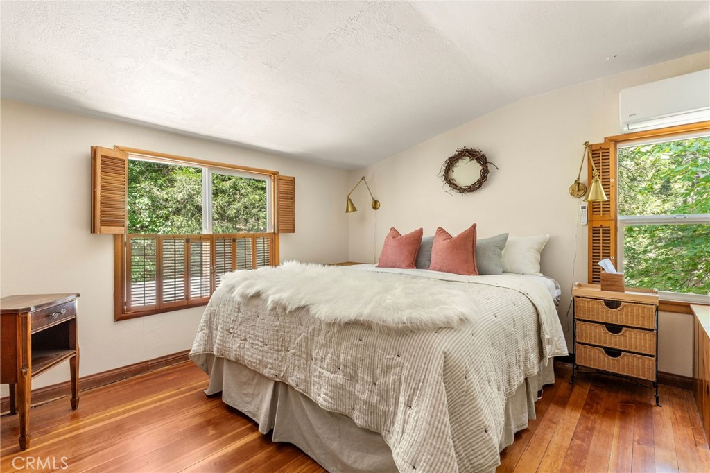 816 Fern Road Lake Arrowhead, CA 92385 - Photo 19 of 35 a bedroom with a bed and wooden floor