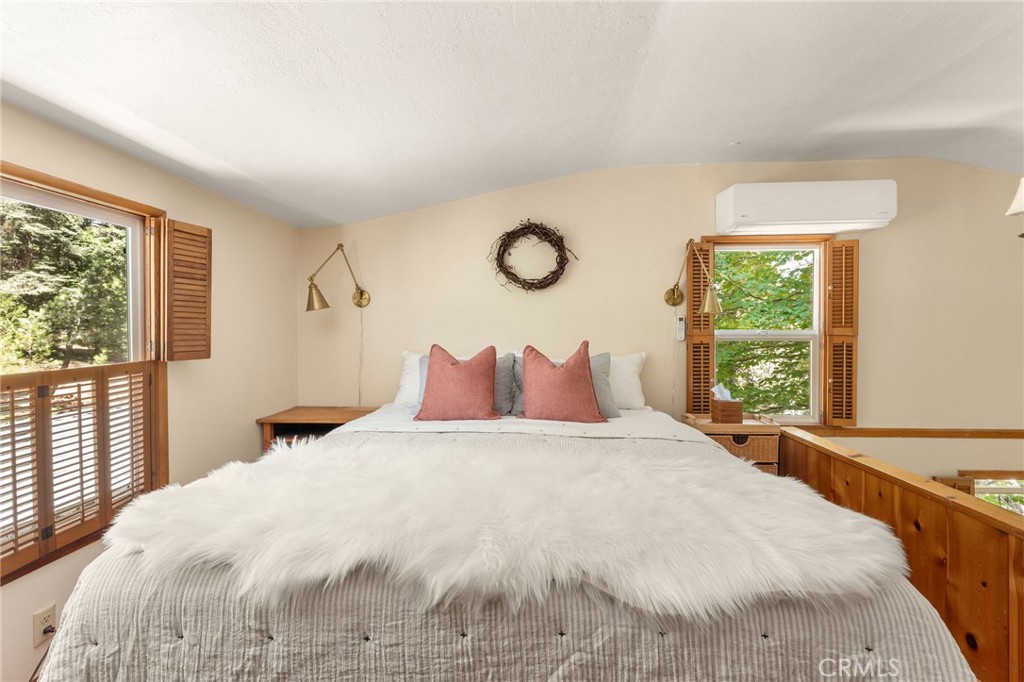 816 Fern Road Lake Arrowhead, CA 92385 - Photo 20 of 35 a large bed sitting in a bedroom next to a window