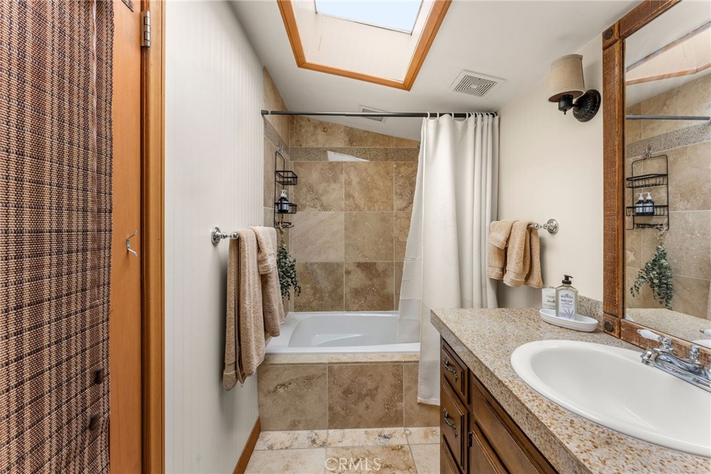 816 Fern Road Lake Arrowhead, CA 92385 - Photo 23 of 35 a bathroom with a granite countertop sink a mirror and shower