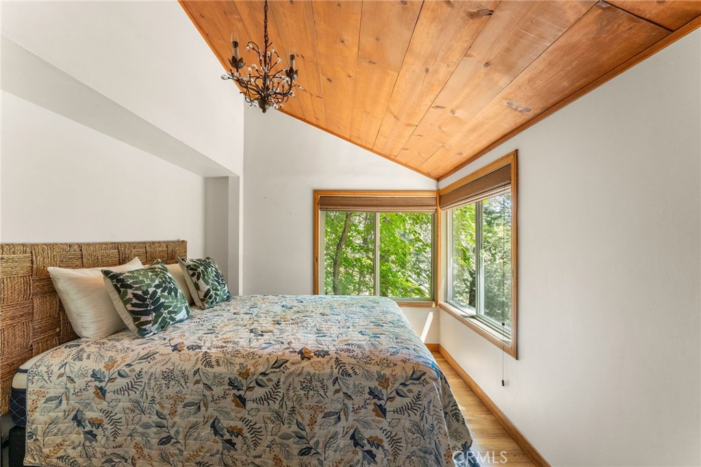 816 Fern Road Lake Arrowhead, CA 92385 - Photo 31 of 35 a bed sitting in a bedroom next to a window