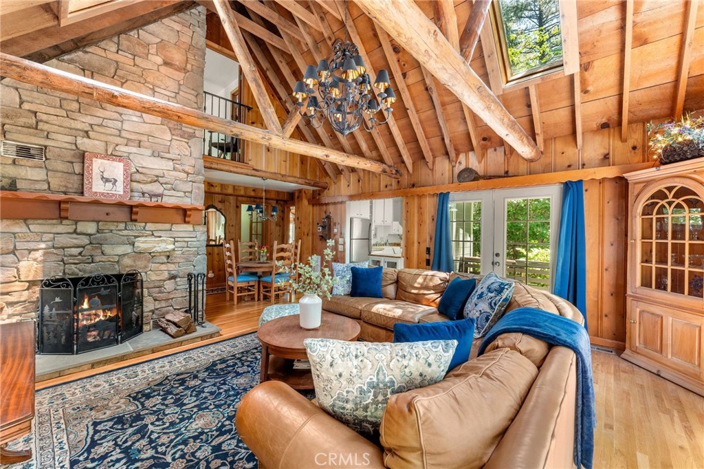 816 Fern Road Lake Arrowhead, CA 92385 - Photo 4 of 35 a living room with furniture a fireplace and a floor to ceiling window