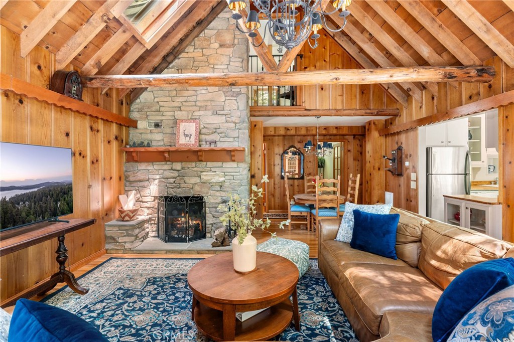 816 Fern Road Lake Arrowhead, CA 92385 - Photo 6 of 35 a living room with furniture a flat screen tv and a fireplace