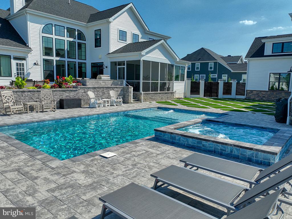 16516 New Road Lewes, DE 19958 - Photo 12 of 109 a front view of a house with a yard table and chairs