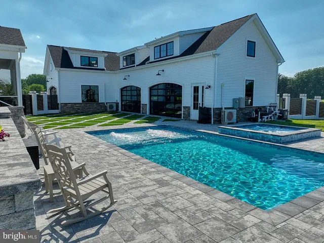 an aerial view of a house with garden space and outdoor seating