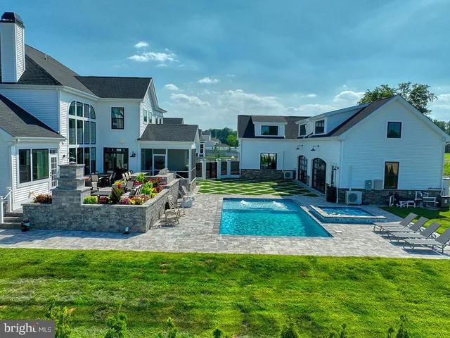 an aerial view of a house with a garden and lake view