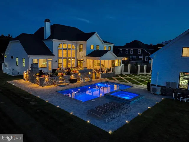 a view of a dining room and livingroom with furniture wooden floor a chandelier