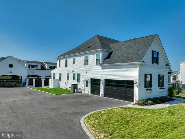 a front view of house with yard and trees in the background