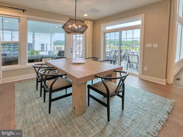 a spacious bedroom with a bed and wooden floor