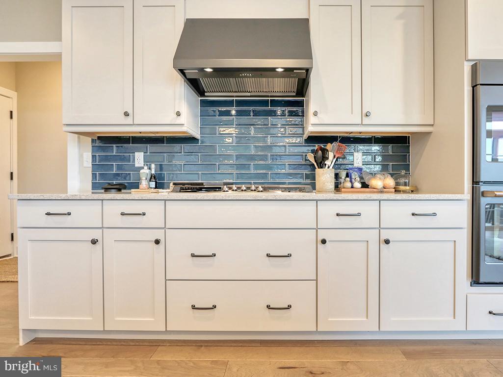 16516 New Road Lewes, DE 19958 - Photo 49 of 109 a kitchen with granite countertop white cabinets and stainless steel appliances