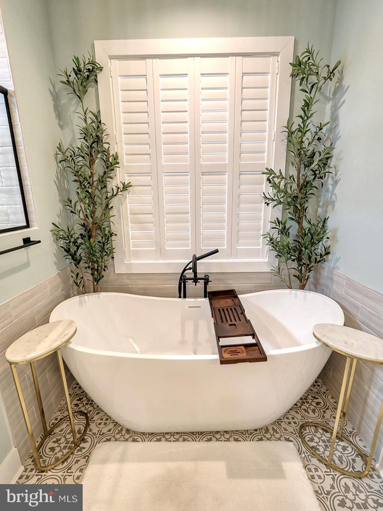 16516 New Road Lewes, DE 19958 - Photo 60 of 109 a white bath tub sitting in a bathroom next to a window