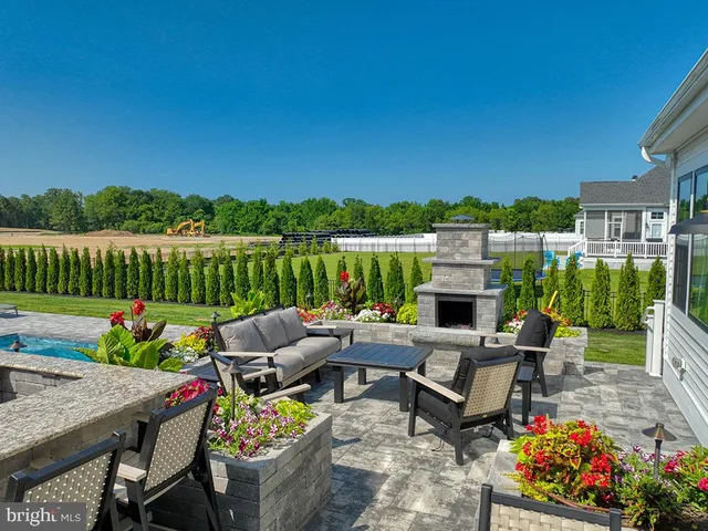 a view of a house with backyard and sitting area