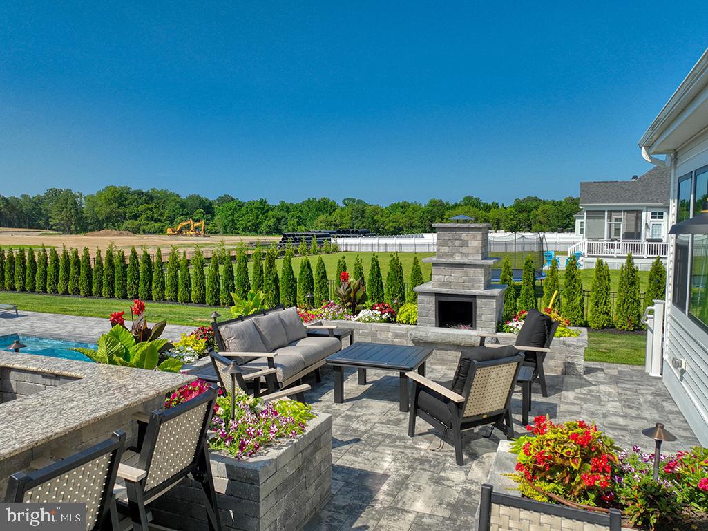 16516 New Road Lewes, DE 19958 - Photo 9 of 109 a view of a patio with couches chairs potted plants and a large tree