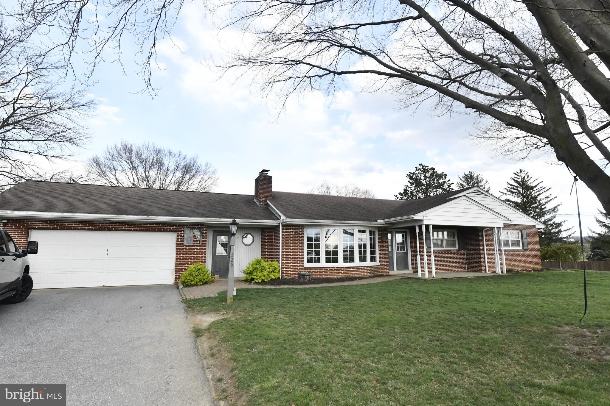 325 May Post Strasburg, PA 17579 - Photo 1 of 22 a front view of a house with garden