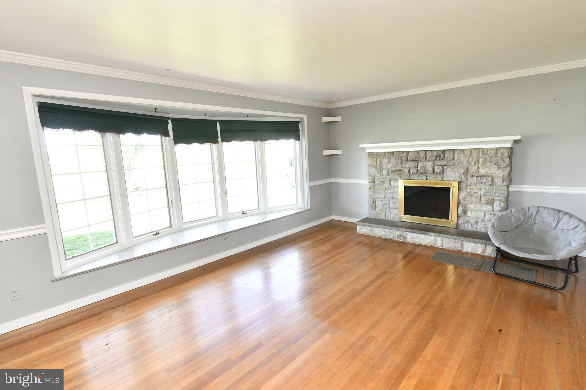 325 May Post Strasburg, PA 17579 - Photo 2 of 22 a living room with a fireplace and wooden floor