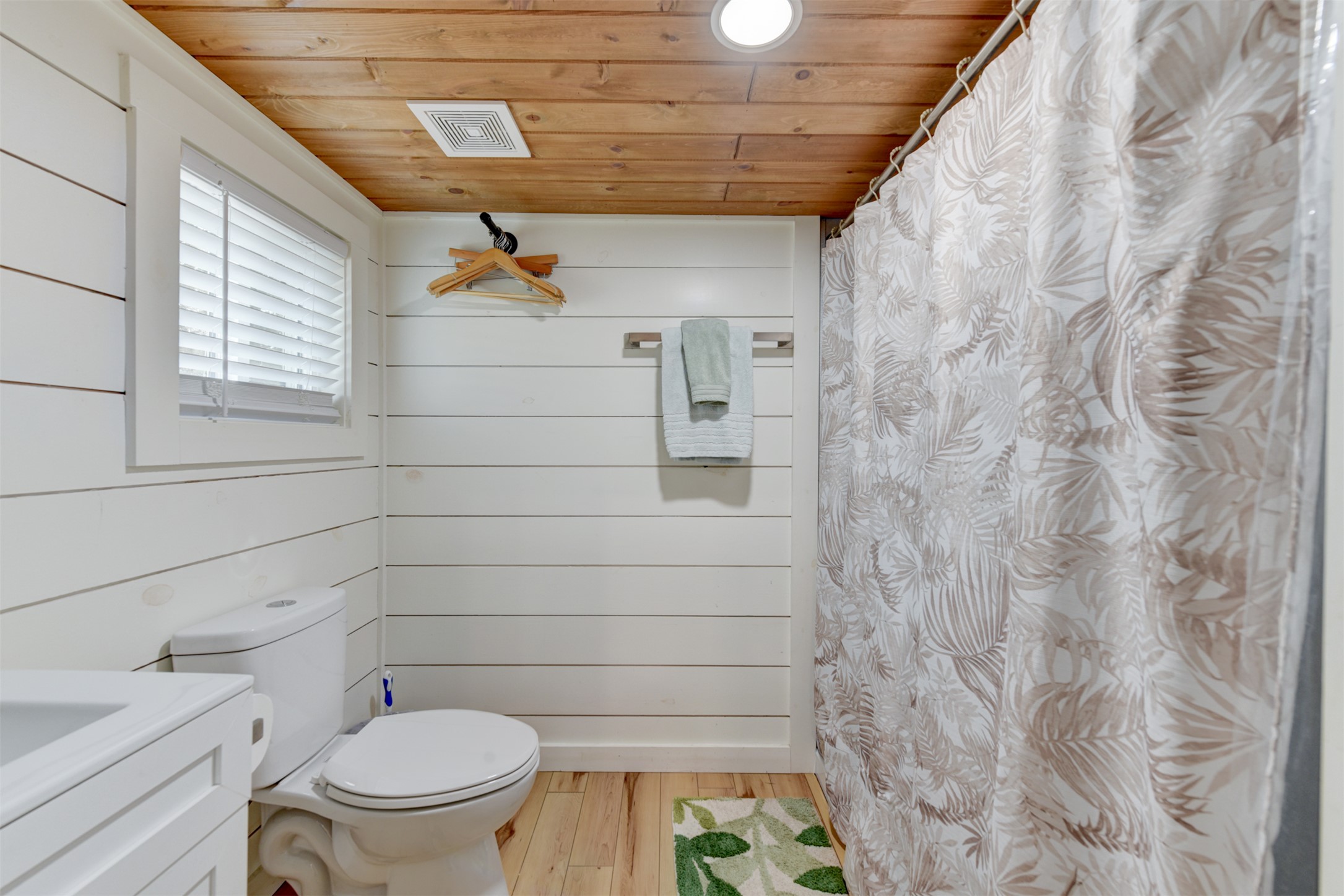 1156 Narrows Road Blanco, TX 78606 - Photo 16 of 40 Bathroom featuring white shiplap walls, wood-finish flooring, and a wood plank ceiling