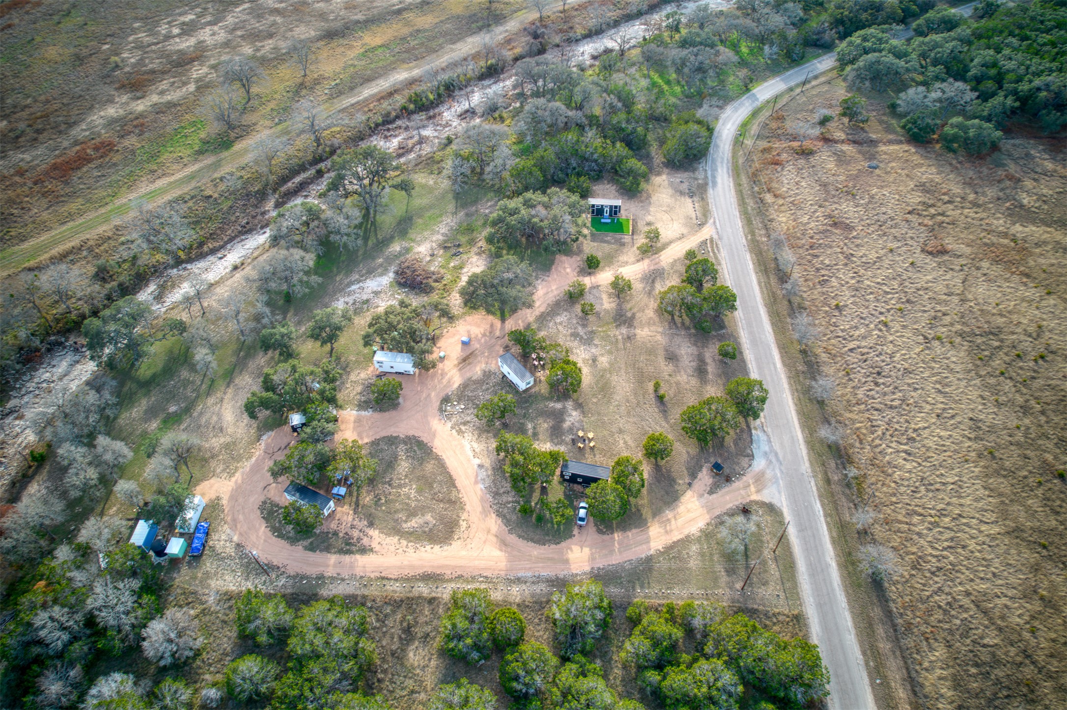 1156 Narrows Road Blanco, TX 78606 - Photo 19 of 40 Aerial perspective of a property featuring multiple structures and a road