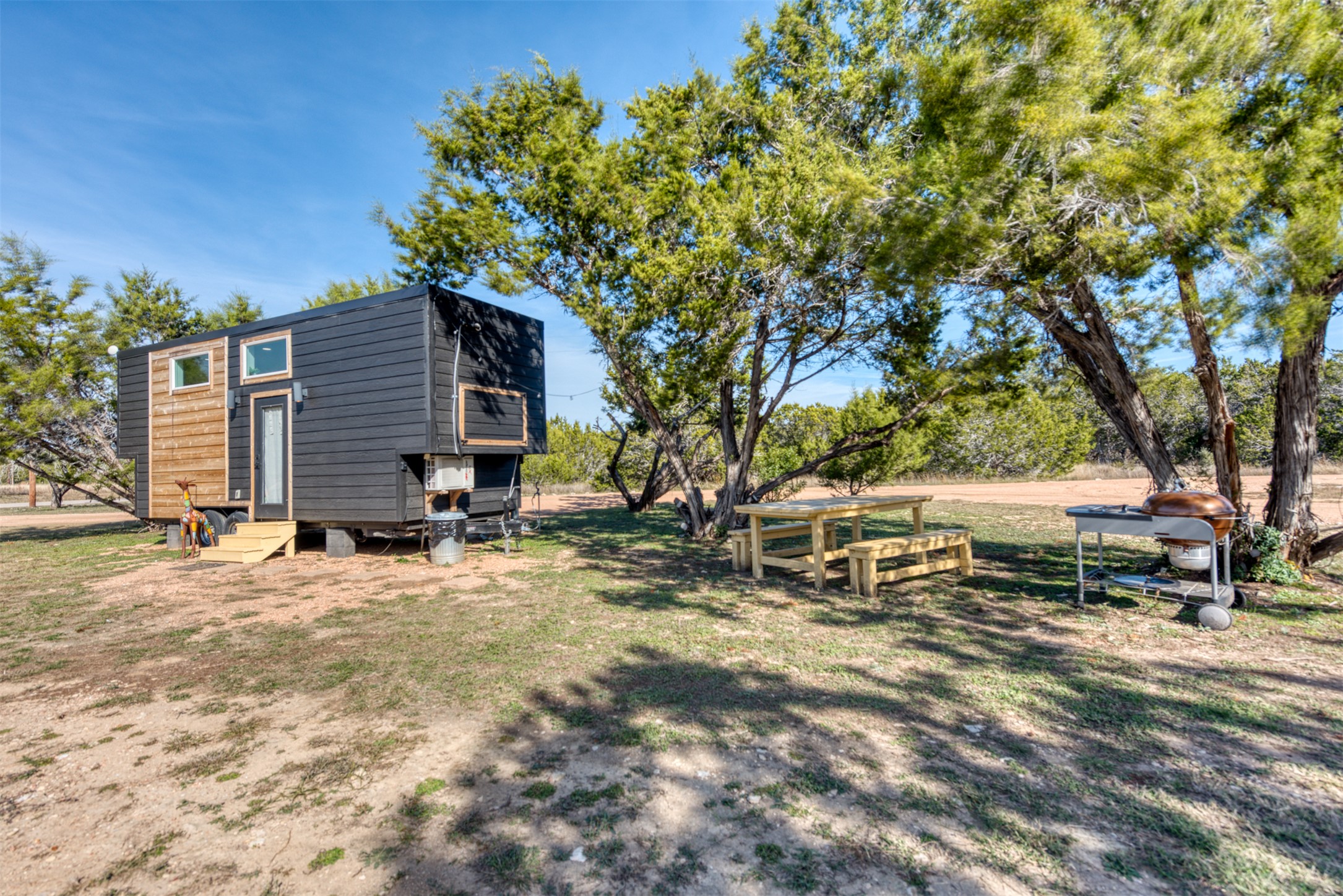 1156 Narrows Road Blanco, TX 78606 - Photo 23 of 40 Compact dwelling featuring dark horizontal siding and natural wood paneling