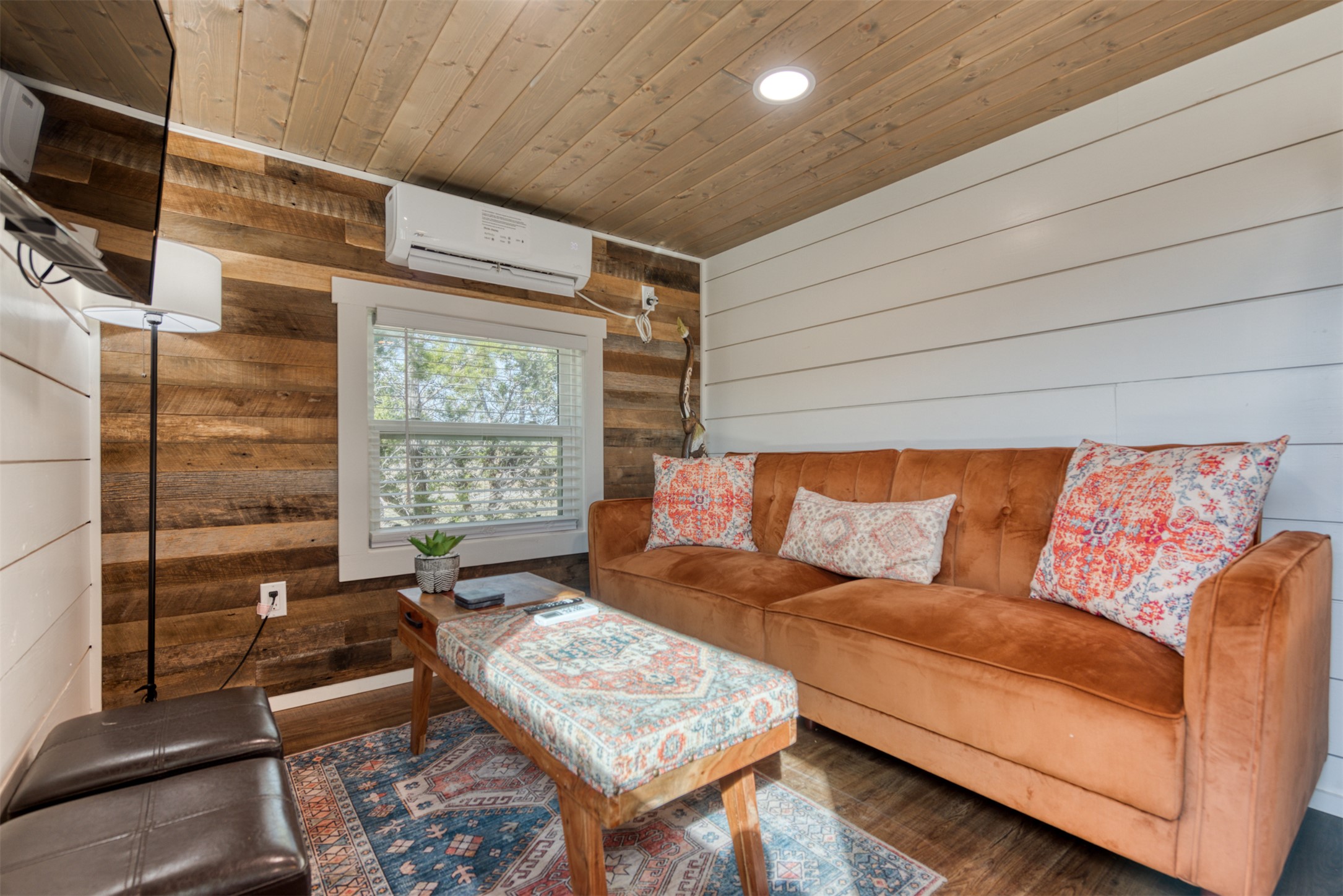 1156 Narrows Road Blanco, TX 78606 - Photo 25 of 40 Living area featuring wood-finish flooring, shiplap accent walls, and a wood-paneled ceiling with recessed lighting