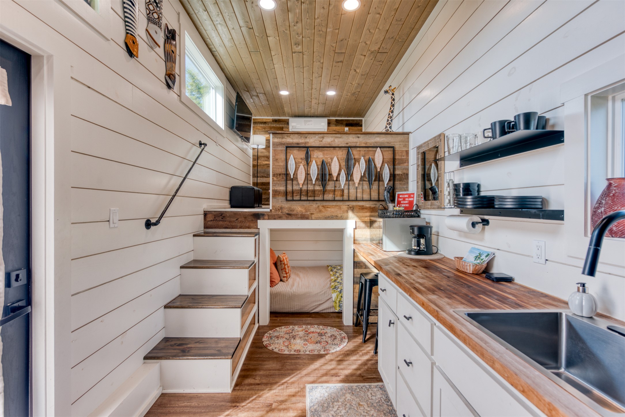1156 Narrows Road Blanco, TX 78606 - Photo 26 of 40 Compact interior featuring white shiplap walls, wood-finish flooring, and a wood-paneled ceiling